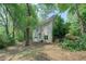 View of the home from the backyard, highlighting the garage and lush greenery at 13935 Brown Bridge Rd, Covington, GA 30016
