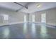 Spacious garage with neutral walls, painted floors, automatic door, and natural light at 13935 Brown Bridge Rd, Covington, GA 30016