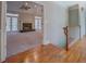 Hardwood hallway leads to living area with fireplace and french doors at 13935 Brown Bridge Rd, Covington, GA 30016