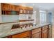 Gourmet kitchen island features granite countertops, cooktop, and rich wood cabinetry at 13935 Brown Bridge Rd, Covington, GA 30016