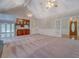 Open living room features a bar, built-in shelving, and wood and glass entry door at 13935 Brown Bridge Rd, Covington, GA 30016