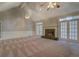 Living room with fireplace, french doors, ceiling fans and vaulted ceiling at 13935 Brown Bridge Rd, Covington, GA 30016