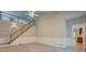 A spacious living room with a staircase, tall ceilings and entry to another room at 13935 Brown Bridge Rd, Covington, GA 30016