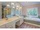 The main bathroom features a soaker tub and shower, and updated fixtures at 13935 Brown Bridge Rd, Covington, GA 30016