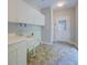 Mud room features neutral walls, tile floors, sink, cabinetry, and access to the exterior at 13935 Brown Bridge Rd, Covington, GA 30016