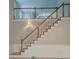 A staircase with white railings and wood banisters leads to an open upper level at 13935 Brown Bridge Rd, Covington, GA 30016