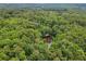 Overview of a property featuring a tranquil pond, surrounded by vibrant woodland at 4025 Demooney Rd, Atlanta, GA 30349