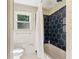 Well-lit bathroom with stylish honeycomb tiled accent wall and modern fixtures for a clean, updated look at 4025 Demooney Rd, Atlanta, GA 30349