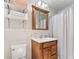 Neat bathroom with wooden vanity, bright lighting, and a shower featuring a curtain and tile at 4025 Demooney Rd, Atlanta, GA 30349