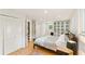 Bright bedroom featuring a comfortable bed, ample closet space, and hardwood floors at 4025 Demooney Rd, Atlanta, GA 30349