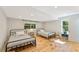 Cozy bedroom featuring twin beds, hardwood floors, and ample natural light from dual windows at 4025 Demooney Rd, Atlanta, GA 30349