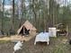 A cozy campsite featuring a canvas tent, dining table, barbecue grill, and ample space for outdoor relaxation at 4025 Demooney Rd, Atlanta, GA 30349