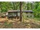 Rear exterior showcasing a large lot, patio, and wooded surroundings, providing privacy and serenity at 4025 Demooney Rd, Atlanta, GA 30349