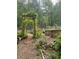 A beautiful garden with raised beds, flowers, and an arbor provides fresh produce and a serene environment at 4025 Demooney Rd, Atlanta, GA 30349