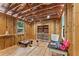 Spacious unfinished interior showing exposed beams, natural light, and wood paneled walls at 4025 Demooney Rd, Atlanta, GA 30349