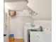Functional laundry area featuring white appliances, shelving for storage and white walls at 4025 Demooney Rd, Atlanta, GA 30349