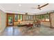 Spacious living room with a ceiling fan and large windows offering natural light and views of the surrounding greenery at 4025 Demooney Rd, Atlanta, GA 30349