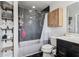 Full bathroom with a shower/tub combo, floating wood shelves and dark tiled floors at 2465 Main St # 201, Atlanta, GA 30344