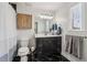Modern bathroom with a black tiled floor, updated vanity, and a window with natural light at 2465 Main St # 201, Atlanta, GA 30344