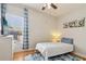 Cozy bedroom with hardwood floors, a comfortable bed, and natural light from the window at 2465 Main St # 201, Atlanta, GA 30344