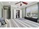 Cozy bedroom featuring hardwood floors, large windows, and a ceiling fan at 2465 Main St # 201, Atlanta, GA 30344