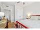 Bedroom with hardwood floors, a red frame bed, and views into another room through the doorway at 2465 Main St # 201, Atlanta, GA 30344