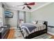 Comfortable bedroom with a ceiling fan, hardwood floors, and a large window at 2465 Main St # 201, Atlanta, GA 30344