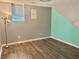Unfurnished basement space with sleek, gray and teal painted walls and laminate wood flooring at 403 Hickory Walk, Woodstock, GA 30188