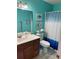 Stylish bathroom with a vanity, toilet, and a shower with a blue and white curtain at 403 Hickory Walk, Woodstock, GA 30188