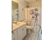 Small bathroom with single sink vanity, toilet, and a shower with decorative curtain at 403 Hickory Walk, Woodstock, GA 30188
