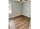 Bright bedroom with hardwood floors and a large window at 403 Hickory Walk, Woodstock, GA 30188