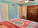 View of a bedroom with light blue walls, a large armoire, and a view into the closet at 403 Hickory Walk, Woodstock, GA 30188