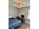 Comfortable bedroom with hardwood floors, desk, and large window at 403 Hickory Walk, Woodstock, GA 30188