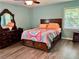 Cozy bedroom featuring a wood dresser and queen bed with unique patterned bedding at 403 Hickory Walk, Woodstock, GA 30188