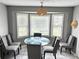 Cozy breakfast nook with a round table, six chairs, and natural light at 403 Hickory Walk, Woodstock, GA 30188