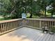 Wooden deck with decorative planters and a view of the backyard trees at 403 Hickory Walk, Woodstock, GA 30188