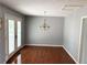 Bright dining room with hardwood floors, a chandelier, and French doors at 403 Hickory Walk, Woodstock, GA 30188