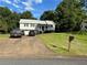 Inviting home with a well-manicured lawn, spacious driveway, and charming front porch at 403 Hickory Walk, Woodstock, GA 30188