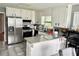Modern kitchen with stainless steel appliances, granite countertops, and white cabinets at 403 Hickory Walk, Woodstock, GA 30188