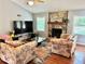 Spacious living room with hardwood floors, fireplace, and a large television at 403 Hickory Walk, Woodstock, GA 30188