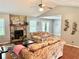 Cozy living room with a stone fireplace, hardwood floors, and comfortable seating at 403 Hickory Walk, Woodstock, GA 30188