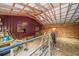 Interior view of a barn with wood beams, stall and storage area at 521 East Valley Ne Rd, Rydal, GA 30171