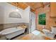 Bright bathroom featuring a soaking tub, a shower, and wood paneling at 521 East Valley Ne Rd, Rydal, GA 30171