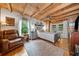Comfortable bedroom featuring a wooden ceiling, a cozy chair, and a view of the outdoors at 521 East Valley Ne Rd, Rydal, GA 30171