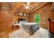 Cozy bedroom featuring wood paneling, a comfortable bed, and a bright window at 521 East Valley Ne Rd, Rydal, GA 30171