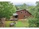 Log cabin exterior featuring a covered porch, garden bed and views of the surrounding forest at 521 East Valley Ne Rd, Rydal, GA 30171