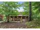 The home features a charming front porch and is surrounded by a beautiful landscape with mature trees and shrubbery at 521 East Valley Ne Rd, Rydal, GA 30171