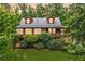 Exterior of log cabin home surrounded by lush greenery featuring dormer windows at 521 East Valley Ne Rd, Rydal, GA 30171