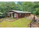 Charming red home with metal roof, small front porch, and fenced-in yard at 521 East Valley Ne Rd, Rydal, GA 30171