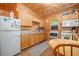 Compact kitchen area with wood cabinets, small appliances, and wood-paneled walls at 521 East Valley Ne Rd, Rydal, GA 30171